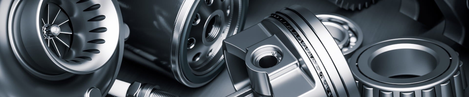 Close-up of precision-engineered automotive components, including a turbocharger, brake rotor, and bearing.