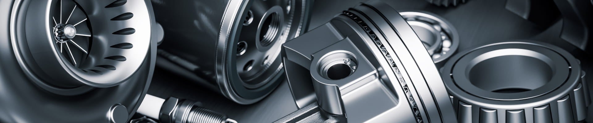 Close-up of various metallic mechanical components, including gears, pistons, and turbine blades.